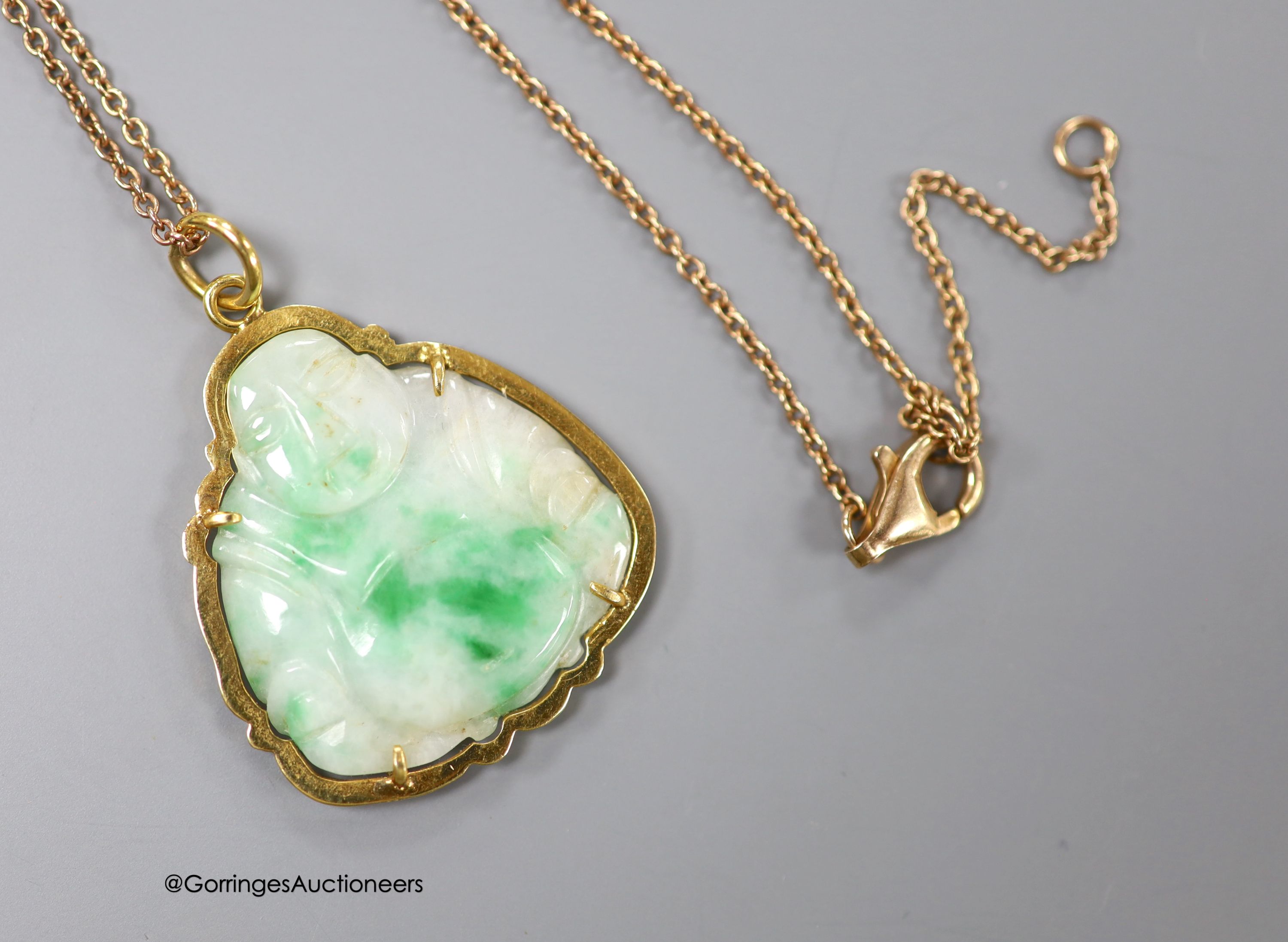 A yellow metal mounted jade pendant, carved as a Buddha, 30mm on a 925 chain.